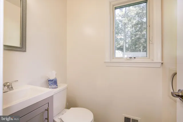 a bathroom with a sink toilet and mirror