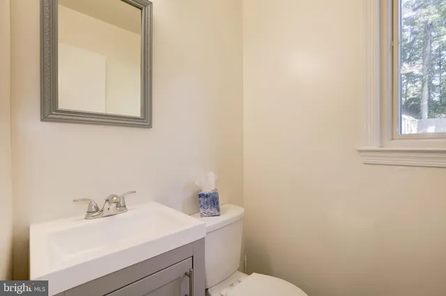 a bathroom with a sink shower and a mirror