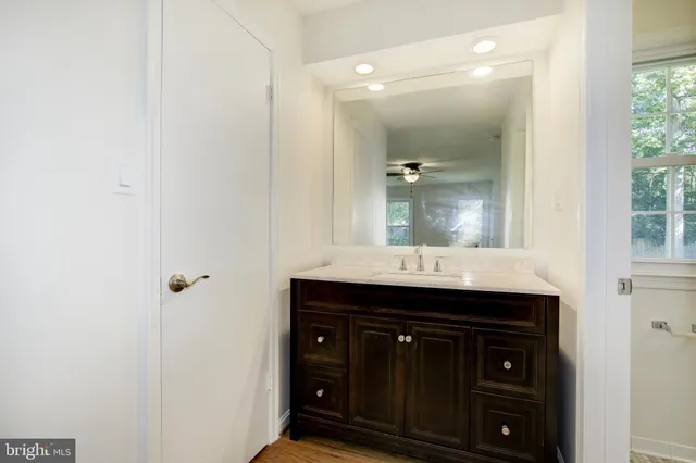 an empty room with a window and ceiling fan