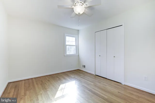 a view of a room with wooden floor and window
