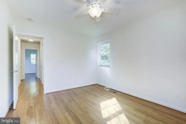 a backyard of a house with lots of green space and wooden fence