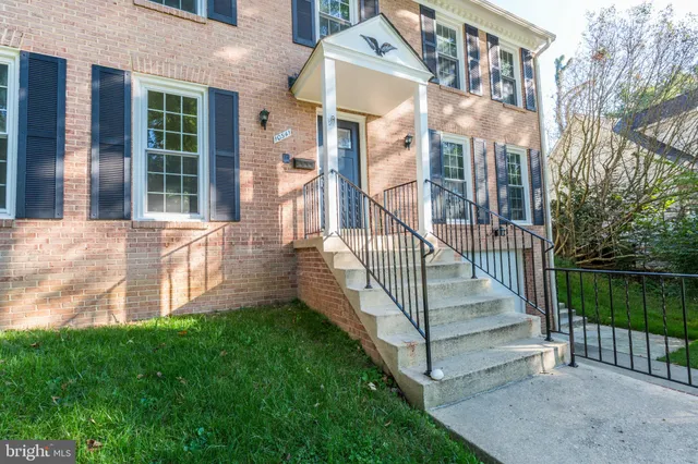 a view of a livingroom with entryway wooden floor and staircase