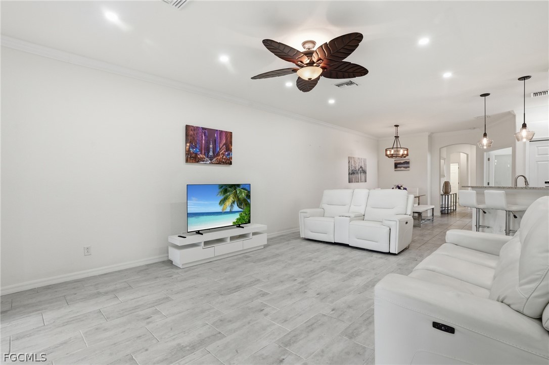 1936 Wellington Street Naples, FL 34120 - Photo 11 of 27 a living room with furniture and a ceiling fan
