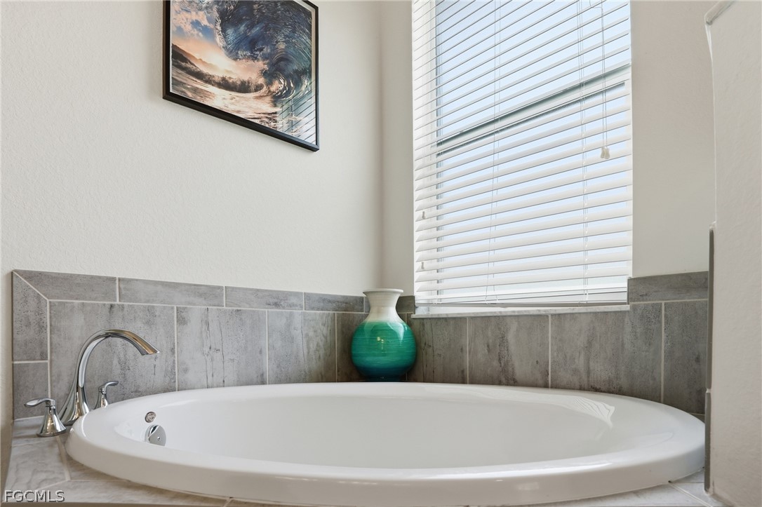 1936 Wellington Street Naples, FL 34120 - Photo 18 of 27 a white bath tub sitting in a bathroom