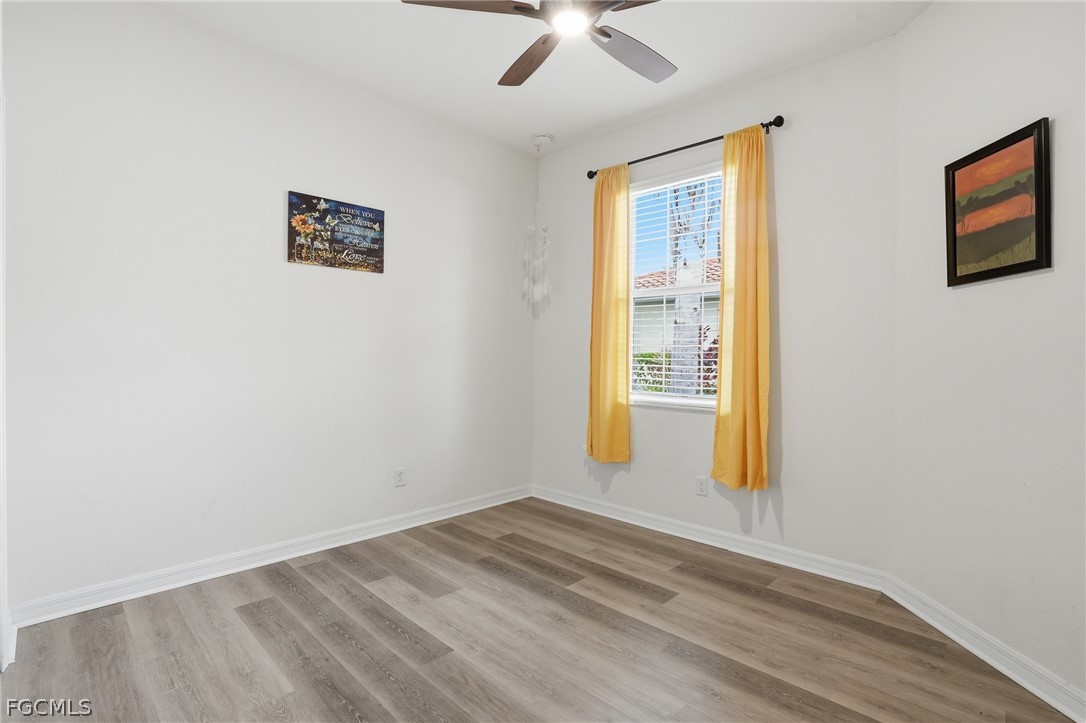 1936 Wellington Street Naples, FL 34120 - Photo 20 of 27 a view of empty room with wooden floor and fan