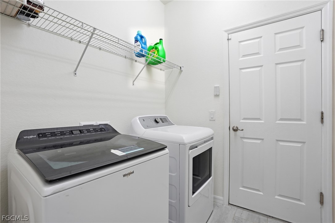 1936 Wellington Street Naples, FL 34120 - Photo 22 of 27 a utility room with dryer and washer