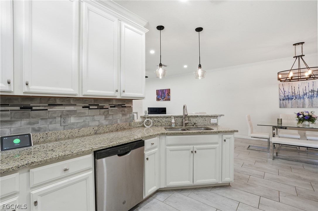 1936 Wellington Street Naples, FL 34120 - Photo 9 of 27 a kitchen with stainless steel appliances granite countertop a sink and cabinets