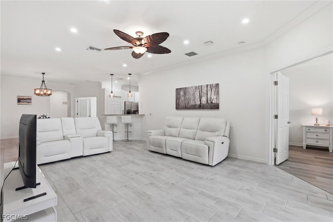 1936 Wellington Street Naples, FL 34120 - Photo 10 of 27 a living room with furniture and a chandelier