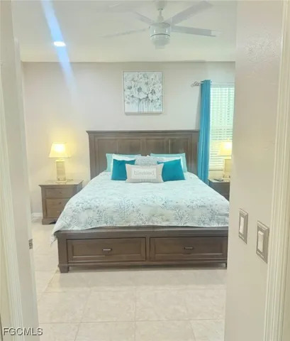 a bedroom with a bed and a painting on the wall