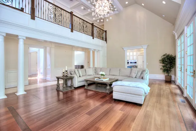 a living room with furniture and a chandelier