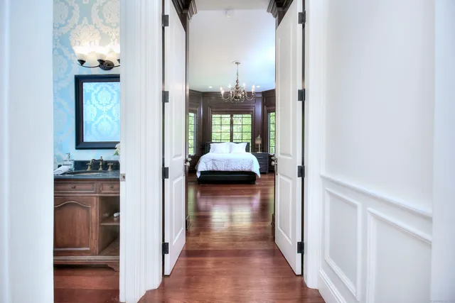 a view of a hallway with wooden floor windows and livingroom