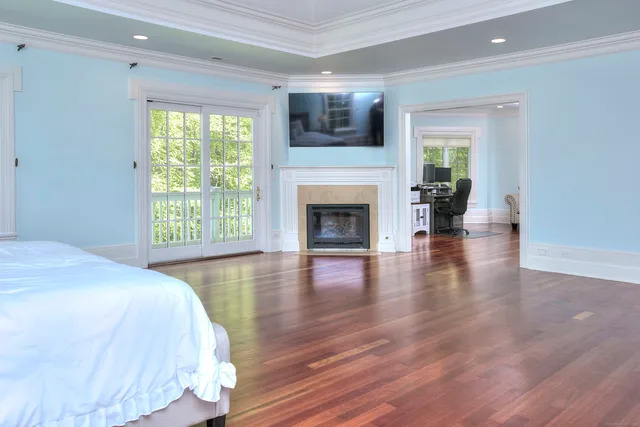 a spacious bedroom with a balcony a bed and a fireplace