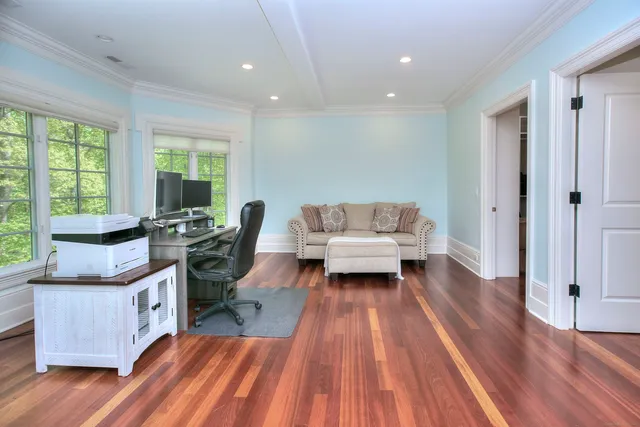 a living room with furniture and a wooden floor