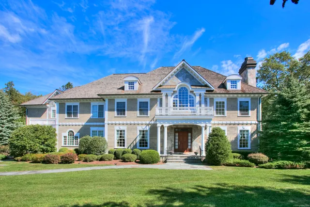 a front view of a house with a garden and plants