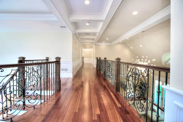 a view of a hallway with wooden floor