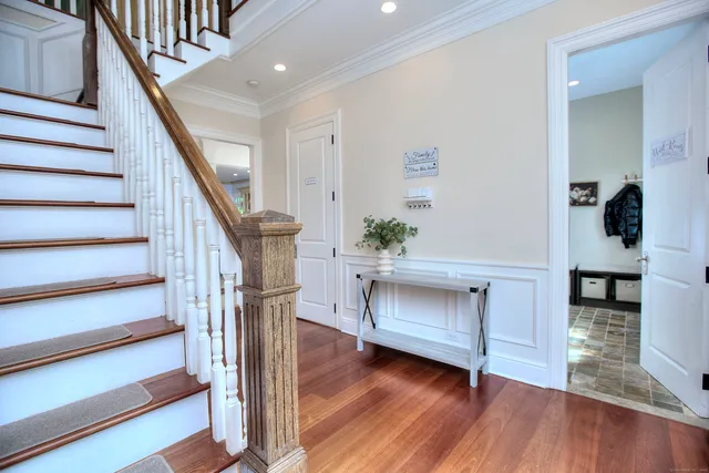 a view of entryway and hall with wooden floor