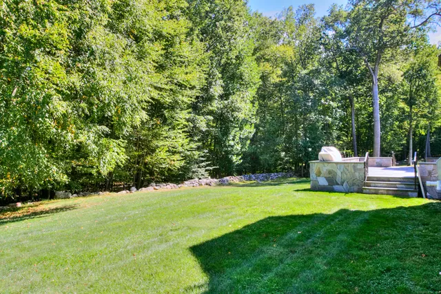 a view of a house with swimming pool and a yard