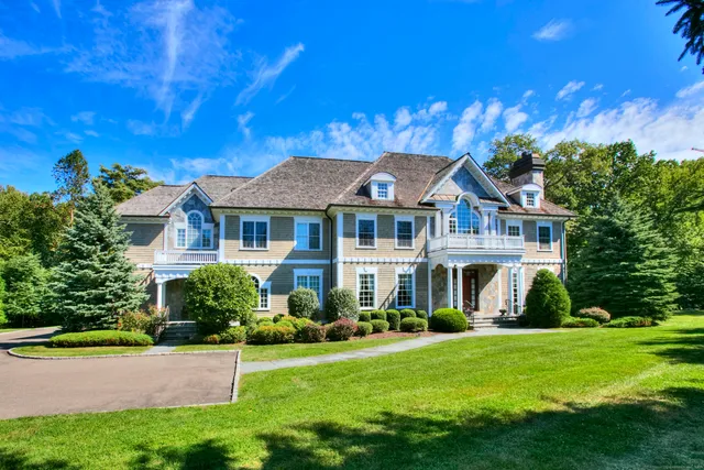 a front view of a house with a yard table and chairs
