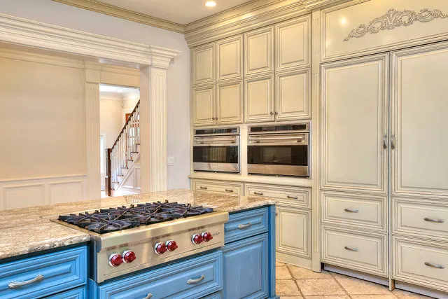 a kitchen with stainless steel appliances granite countertop a stove and a microwave