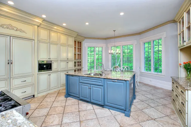 a open kitchen with stainless steel appliances granite countertop a stove a sink and a refrigerator