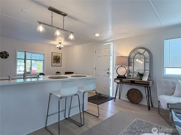 a kitchen with sink stove and view living room