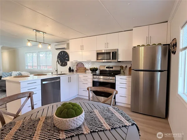 a kitchen with stainless steel appliances a refrigerator stove microwave and sink