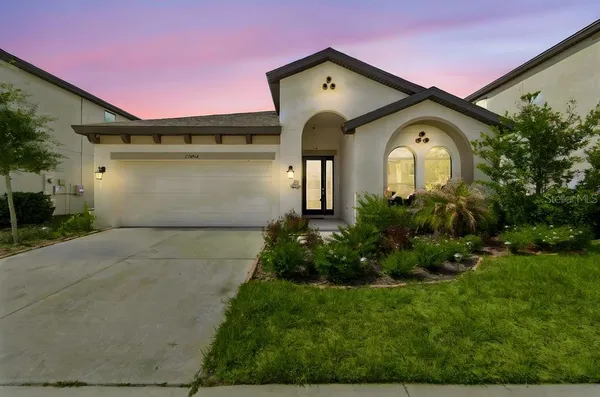 a front view of a house with a garden