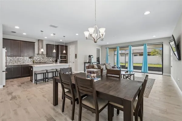 a kitchen with a refrigerator sink and white cabinets