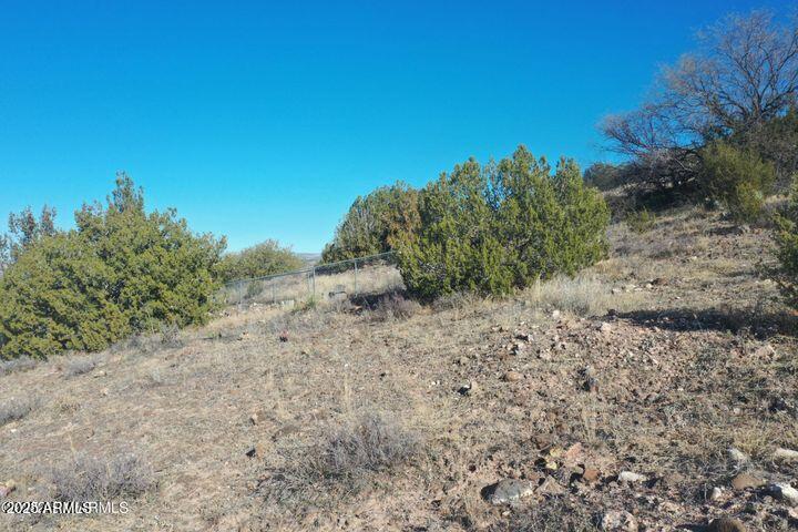 3570 Warrior Rest, Unit 132 Rimrock, AZ 86335 - Photo 16 of 31 a view of a dry yard with trees in the background