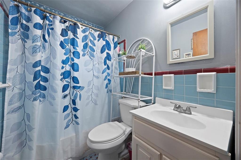 1421 Fleming Avenue McKees Rocks, PA 15136 - Photo 17 of 36 a bathroom with a sink and mirror with toilet