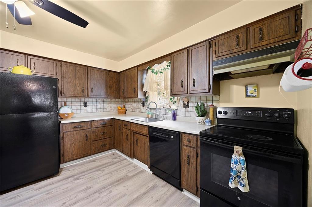1421 Fleming Avenue McKees Rocks, PA 15136 - Photo 4 of 36 a kitchen with a sink stove and refrigerator