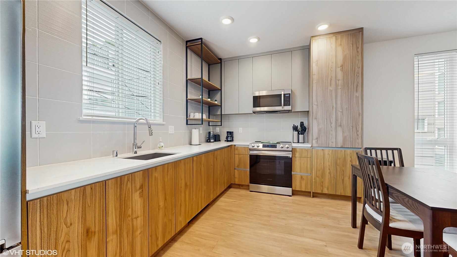 444 13th Avenue Seattle, WA 98122 - Photo 12 of 36 a kitchen with stainless steel appliances granite countertop a sink stove microwave and refrigerator