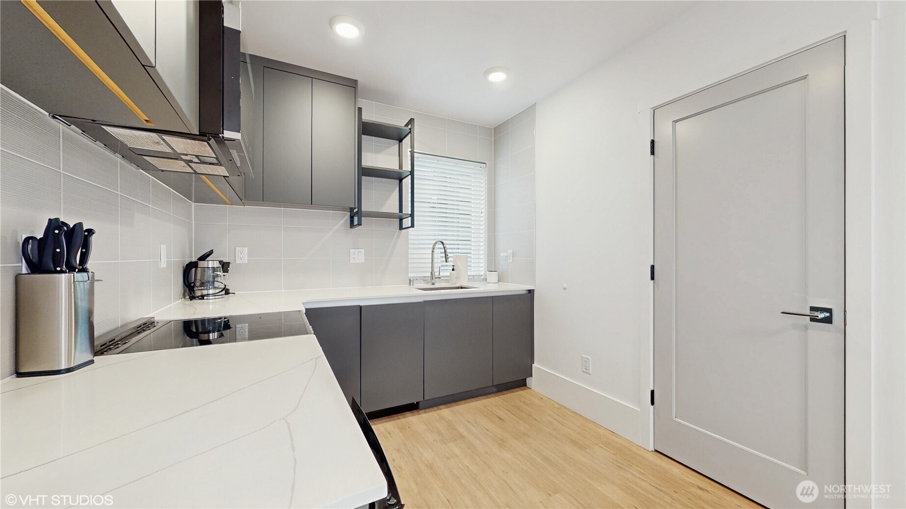 444 13th Avenue Seattle, WA 98122 - Photo 22 of 36 a kitchen with kitchen island a sink stove and refrigerator