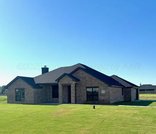 a large house with a big yard and large trees