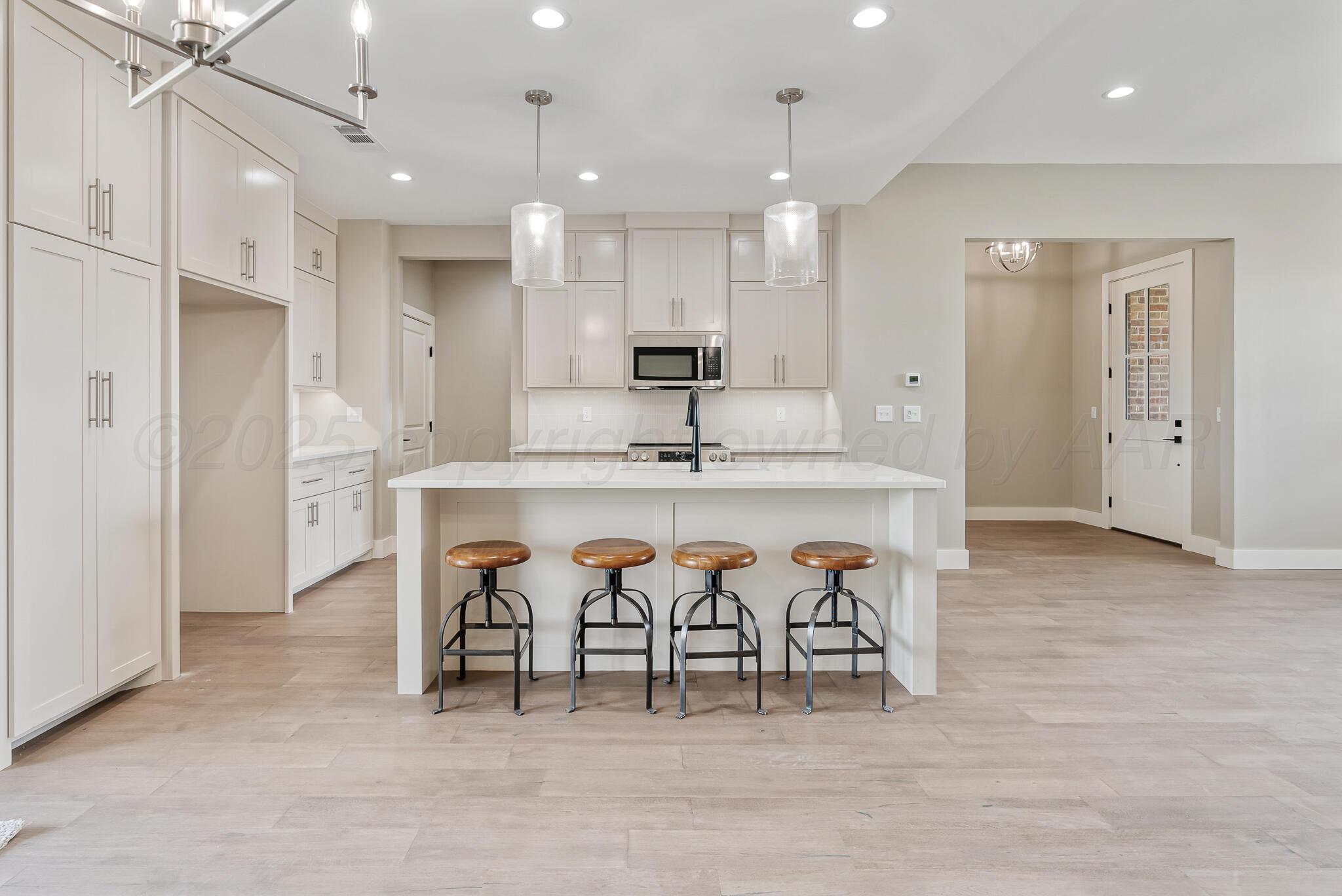 19100 Buck Springs Road Amarillo, TX 79119 - Photo 14 of 29 a large kitchen with stainless steel appliances kitchen island granite countertop a table and chairs in it