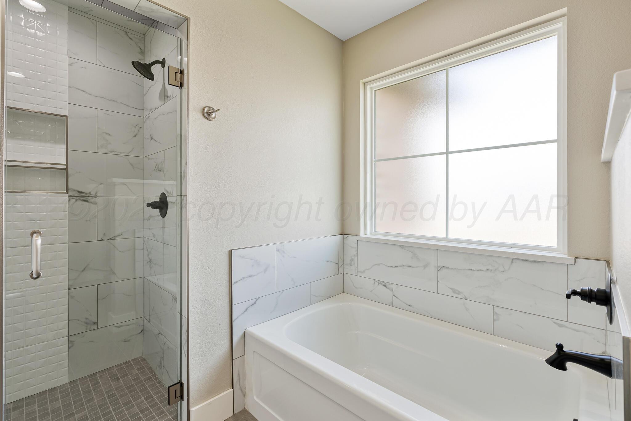 19100 Buck Springs Road Amarillo, TX 79119 - Photo 19 of 29 a white bath tub sitting next to a window