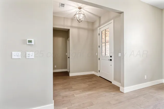 an empty room with fireplace and windows