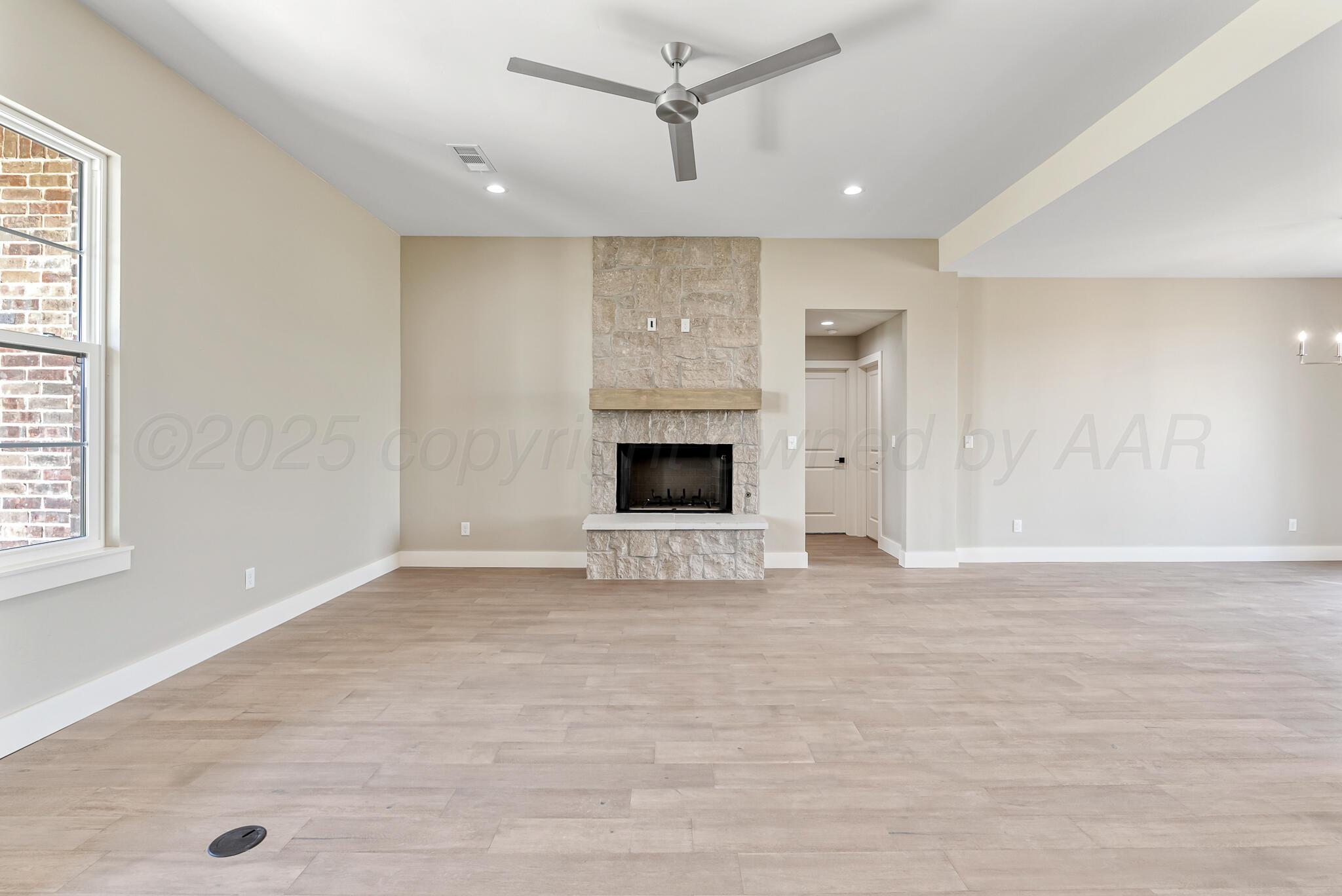 19100 Buck Springs Road Amarillo, TX 79119 - Photo 10 of 29 an empty room with fireplace and windows