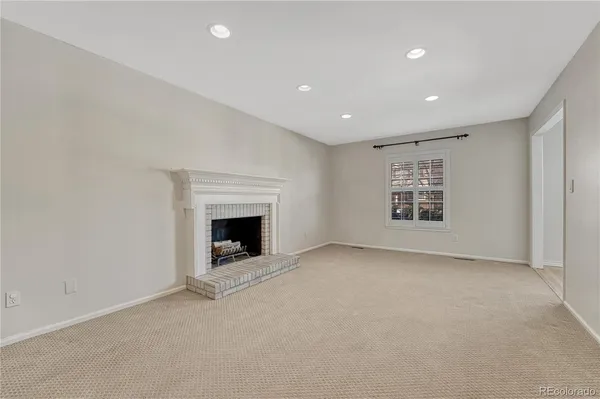 a view of an empty room with a fireplace