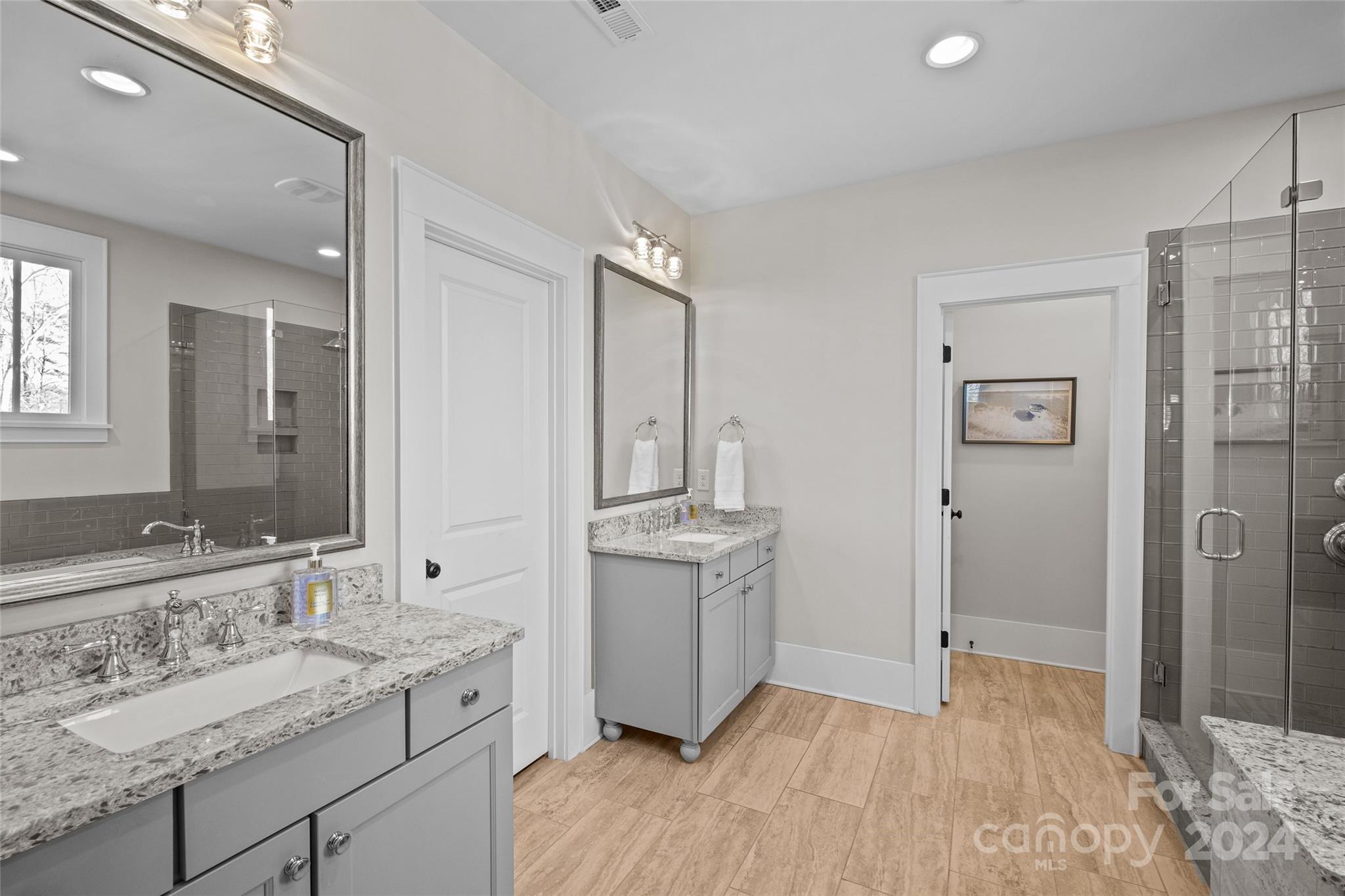 5629 Closeburn Road Charlotte, NC 28210 - Photo 29 of 44 a bathroom with a granite countertop sink a mirror a shower and a bathtub
