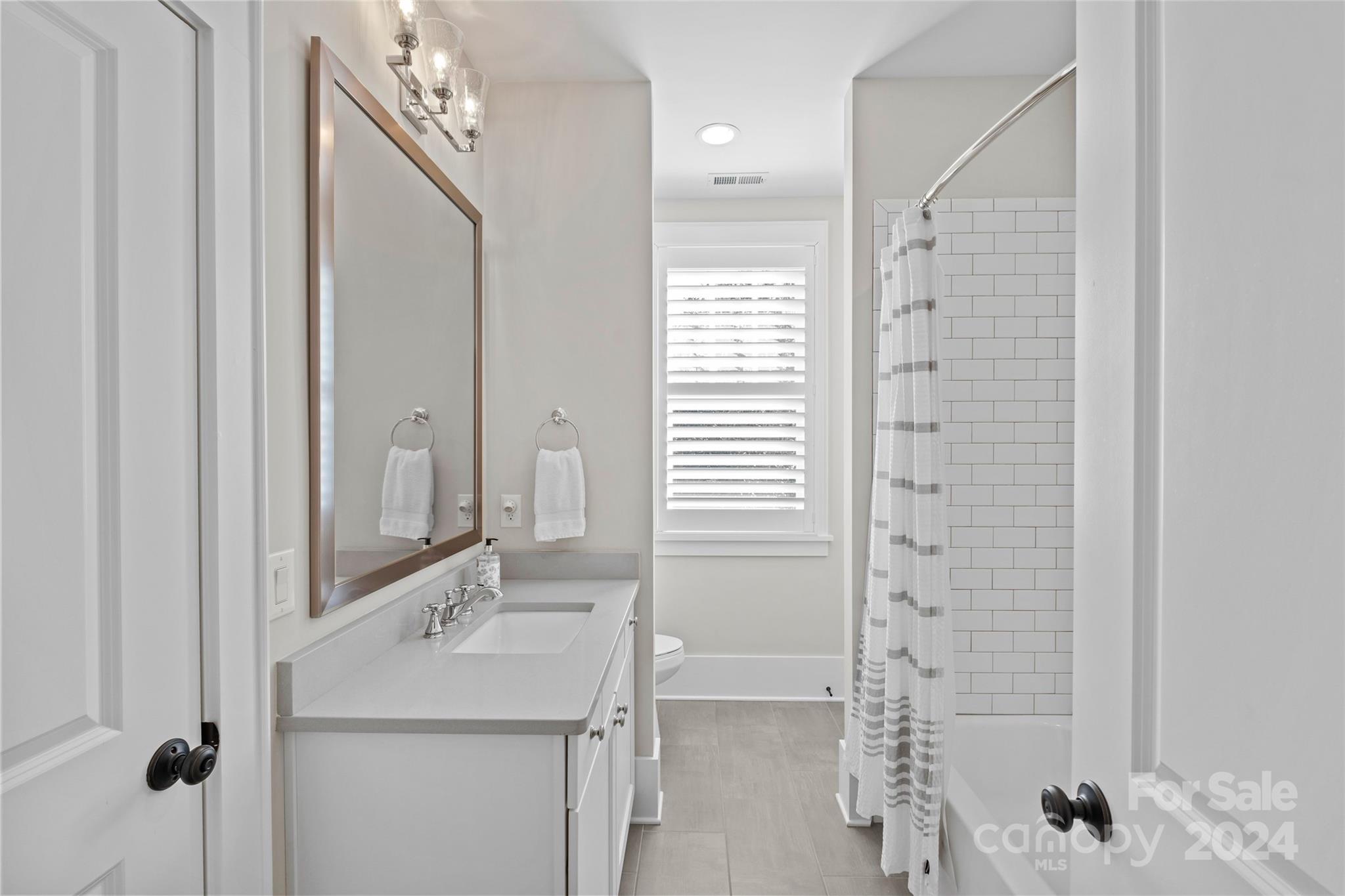 5629 Closeburn Road Charlotte, NC 28210 - Photo 37 of 44 a bathroom with a sink and mirror