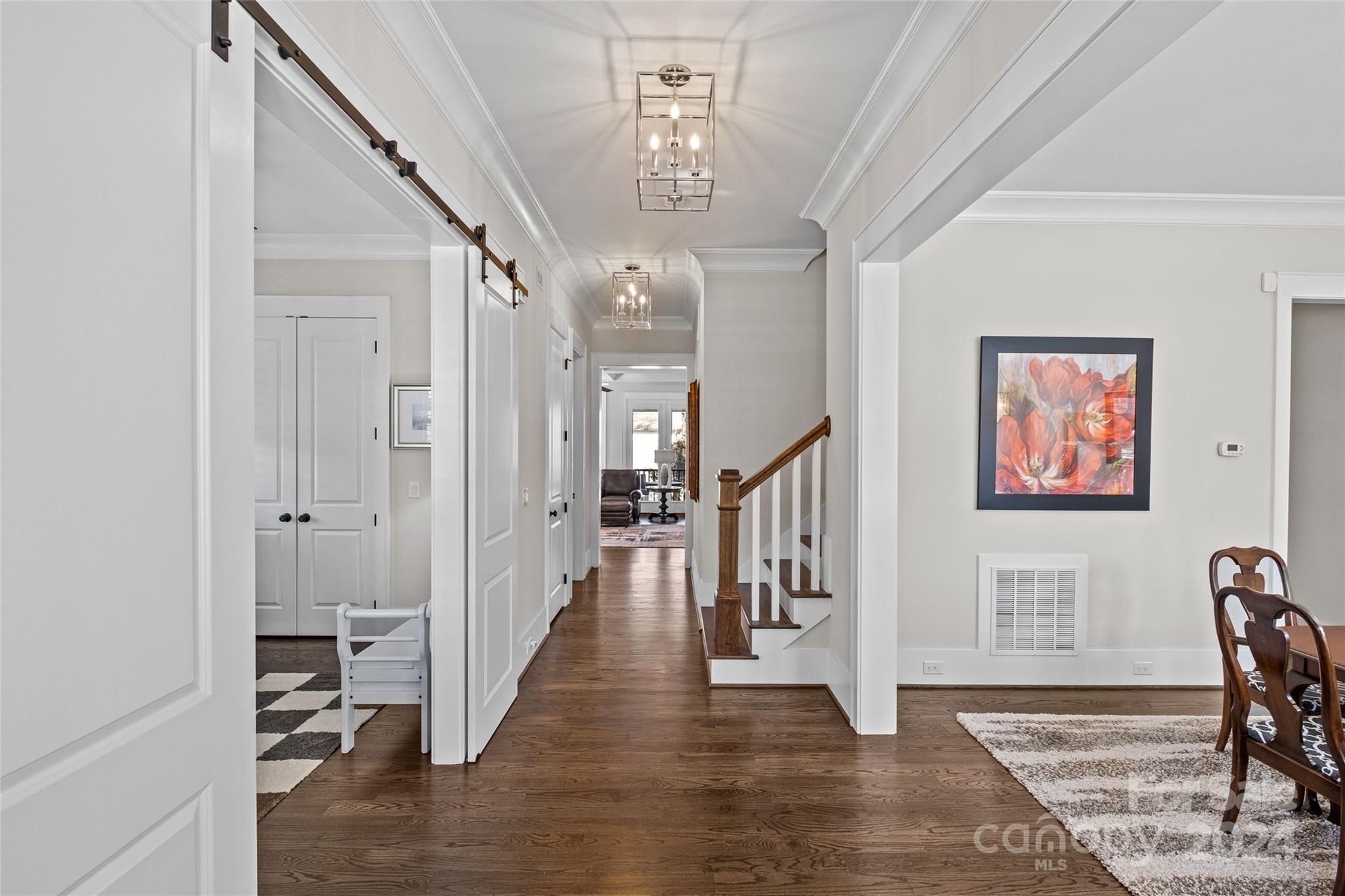 5629 Closeburn Road Charlotte, NC 28210 - Photo 7 of 44 a view of a hallway with wooden floor and staircase
