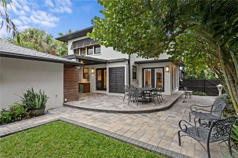 a view of house with backyard outdoor seating and green space