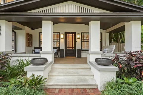a lobby with furniture and a potted plant