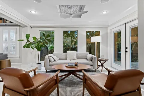 a living room with furniture potted plant and a window