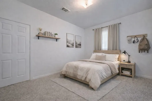 a spacious bedroom with a bed and a window