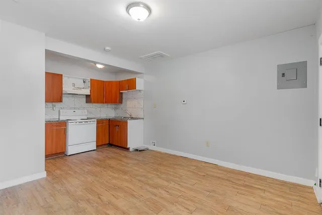 a kitchen with granite countertop a sink and a stove top oven