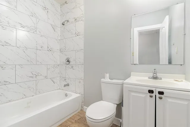 a bathroom with a toilet a sink and bathtub