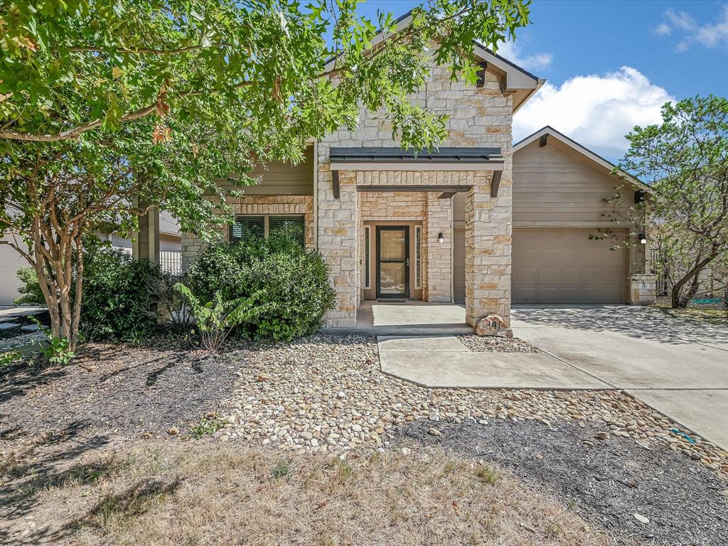 A stone facade and integrated garage offer appealing curb appeal.