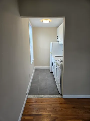 a view of a kitchen from a hallway